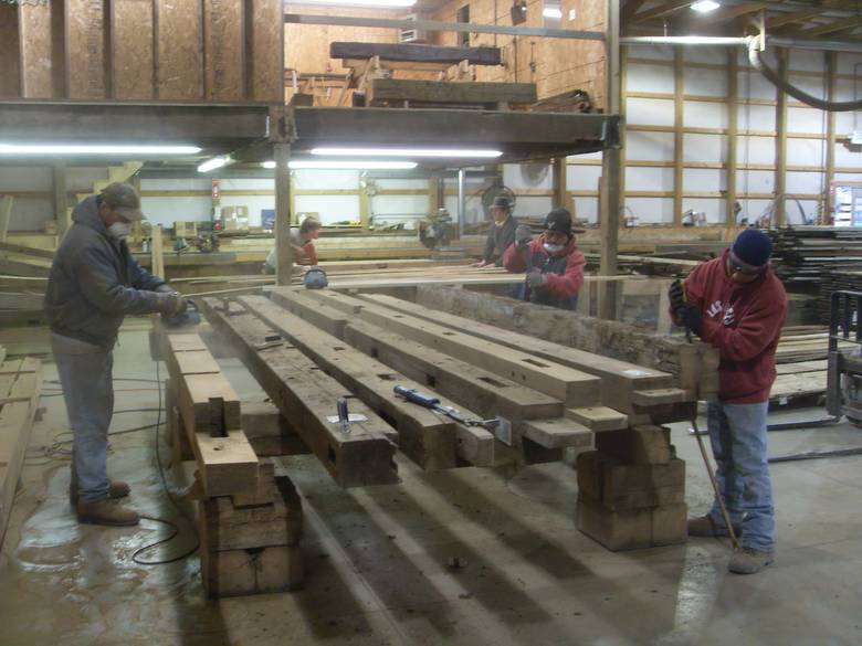Camp Barn Restoration / Cannon Salvage workers cleaning, applying borate, and waxing the frame.